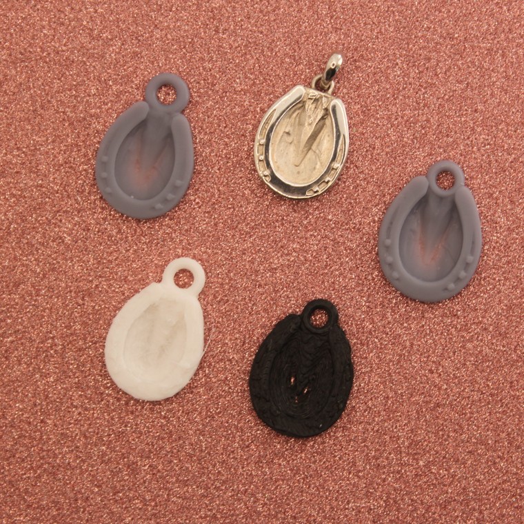 The pendant through its stages, from model to finished silver