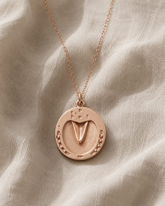 Finished rose gold hoofprint pendant on a chain