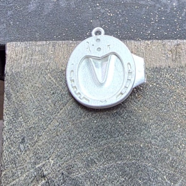 A pendant taking shape on the jeweller's bench